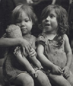 Child playing with broken doll